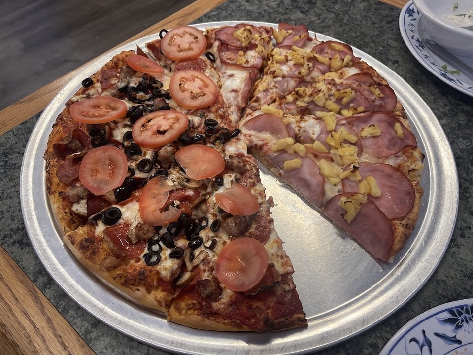 Restaurant menu featuring pizza, salads, and sides.