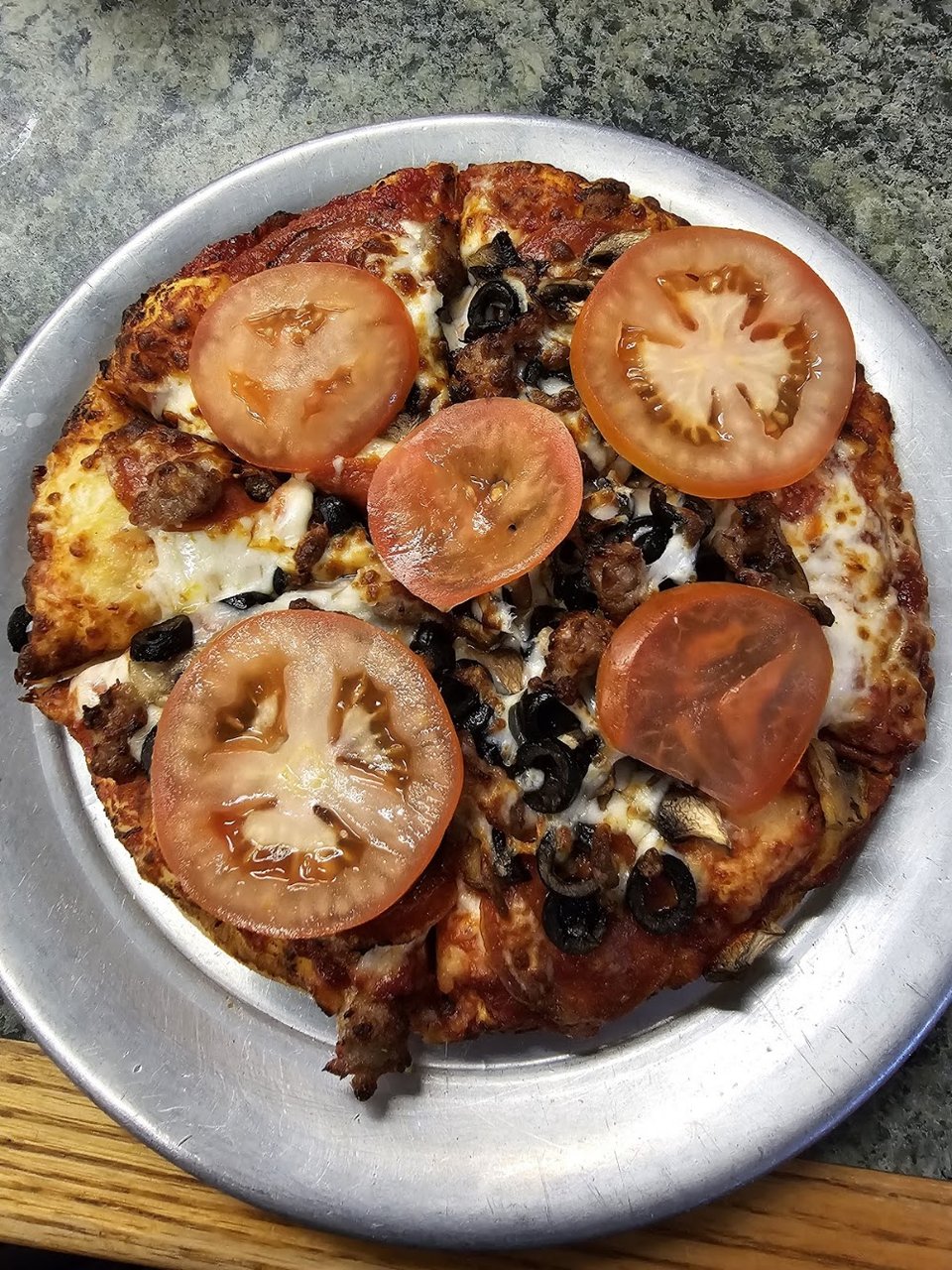 Menu board with classic grill items and pizza.