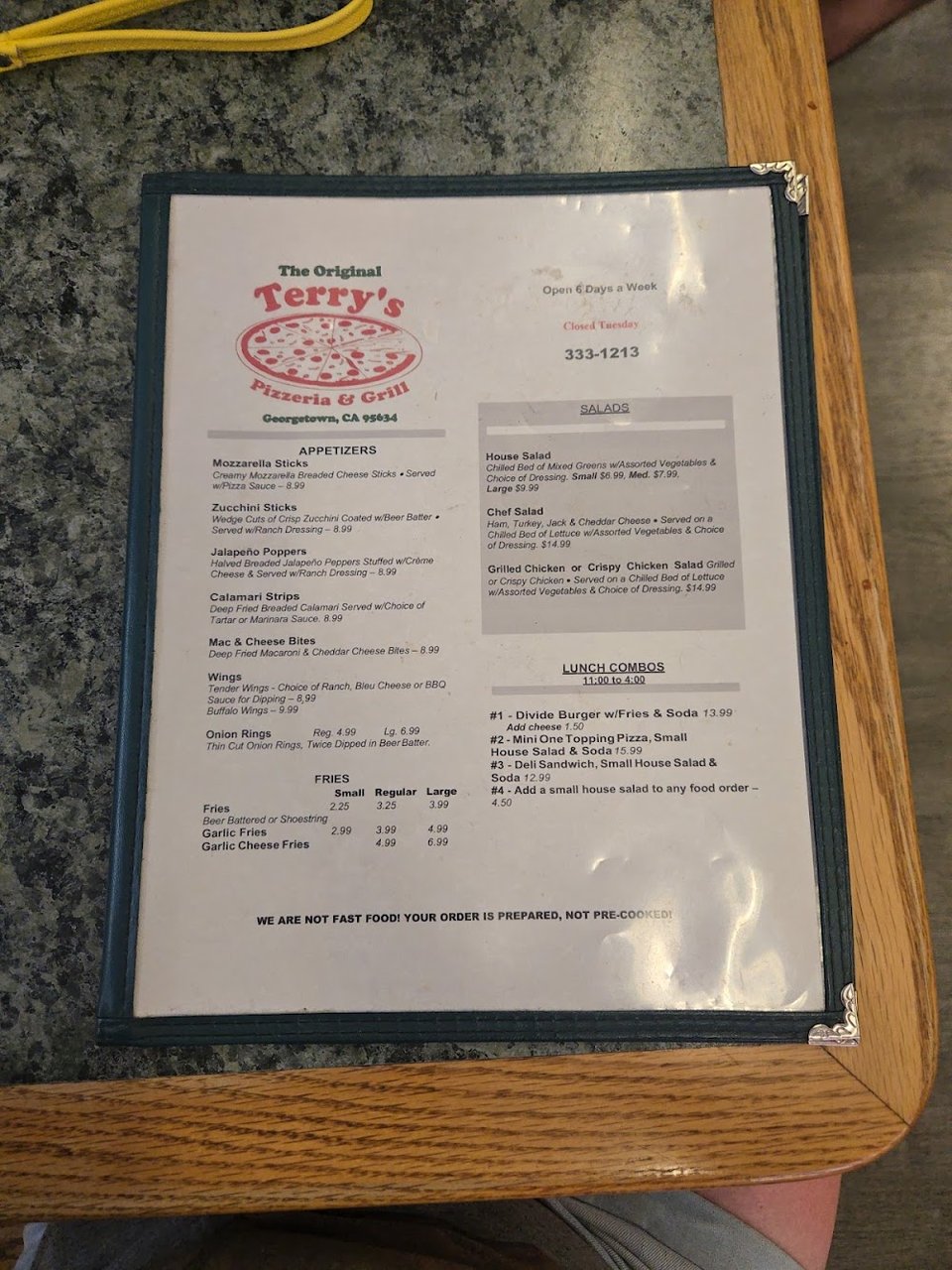 Restaurant menu featuring pizza, salads, and sides.
